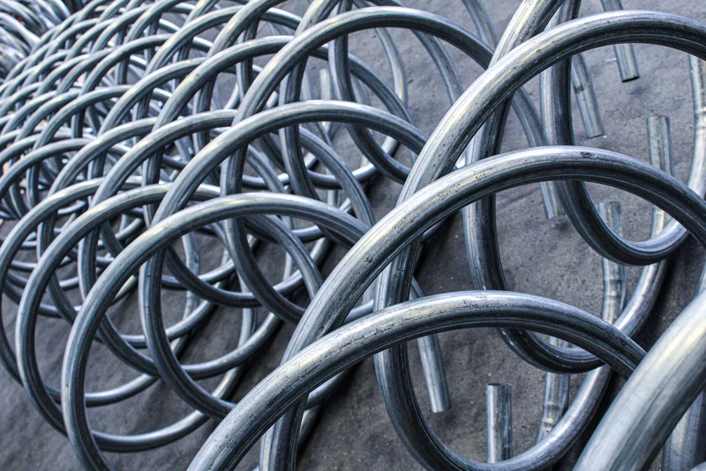 curved metal pipes laid on the floor